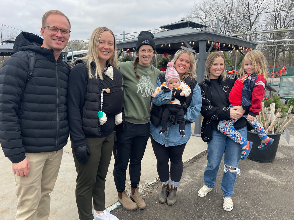 Megan with guests at Open House, including adults and kids