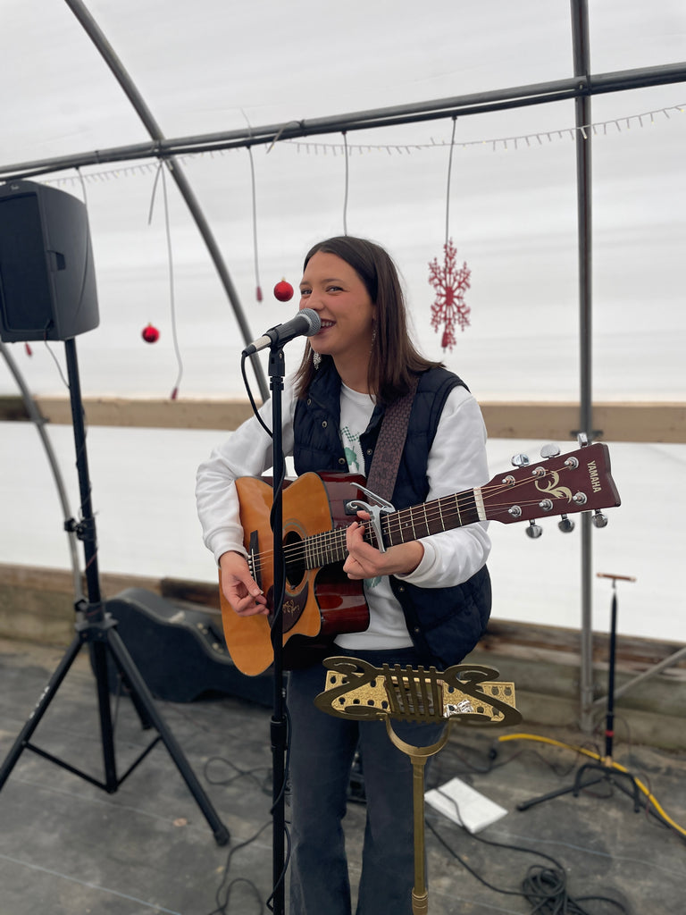 Maddie Ball singing and playing guitar at our Open House.